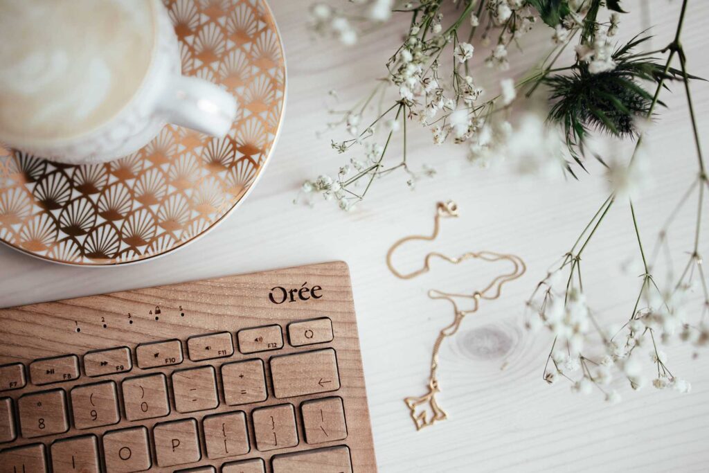 SEO Content Wooden keyboard with coffee mug and flowers in the background