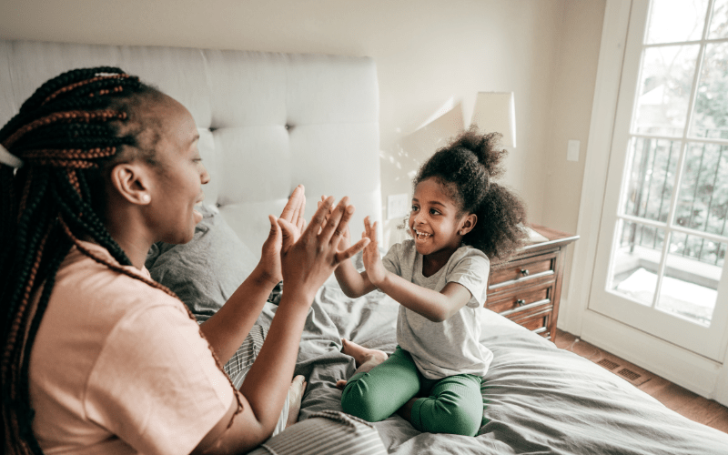 happy mom and daughter doing a high five.