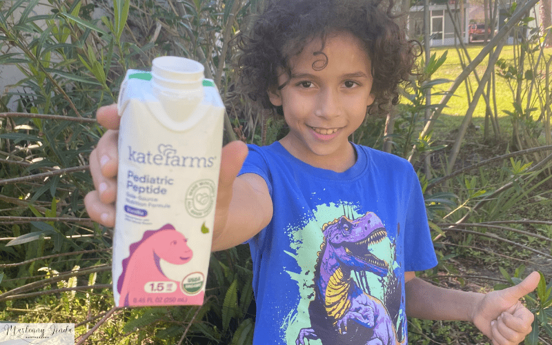health and nutrition Kate Farms Shakes. Anthony smiling and holding his shake.