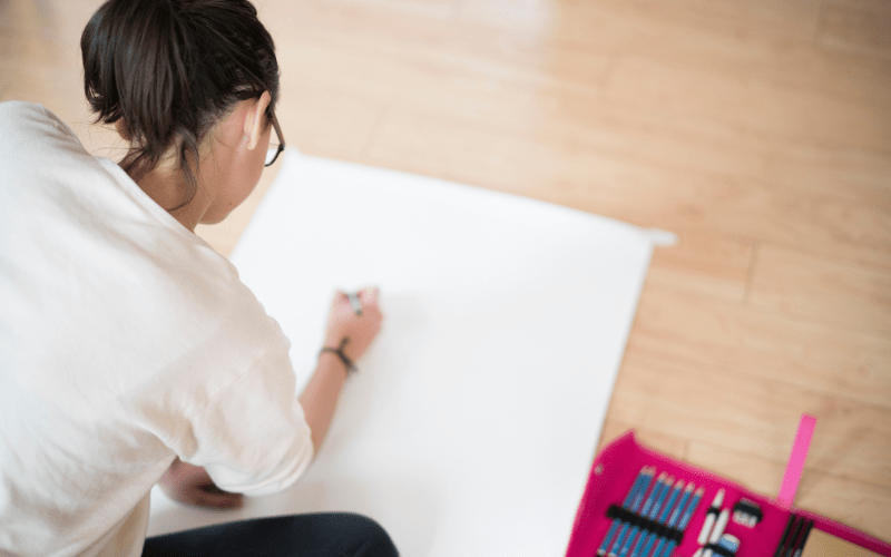teenager sketching a drawing of a complicated picture