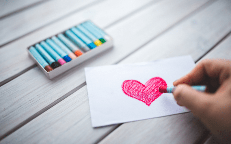 a small pink heart colored out of crayons