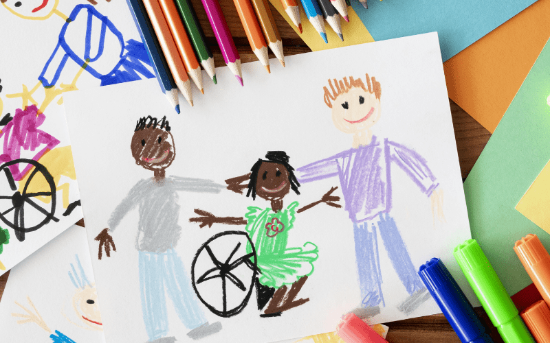 A happy smiling brown girl in a wheelchair