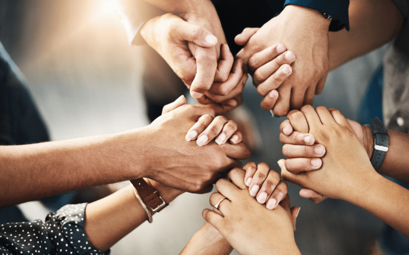 images of hands symbolizing unity and helping others