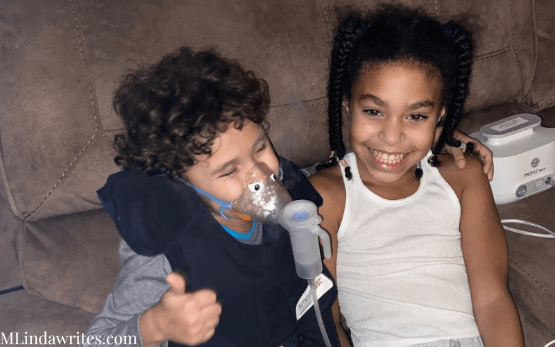 Two adorable children a little boy and girl helping others with cystic fibrosis is important and the boy is doing his treatment