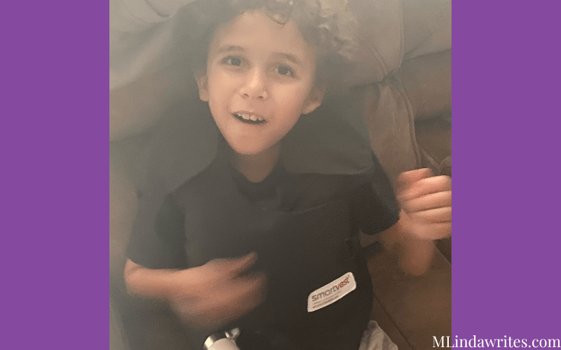 a cute little boy wearing a smartvest for cystic fibrosis