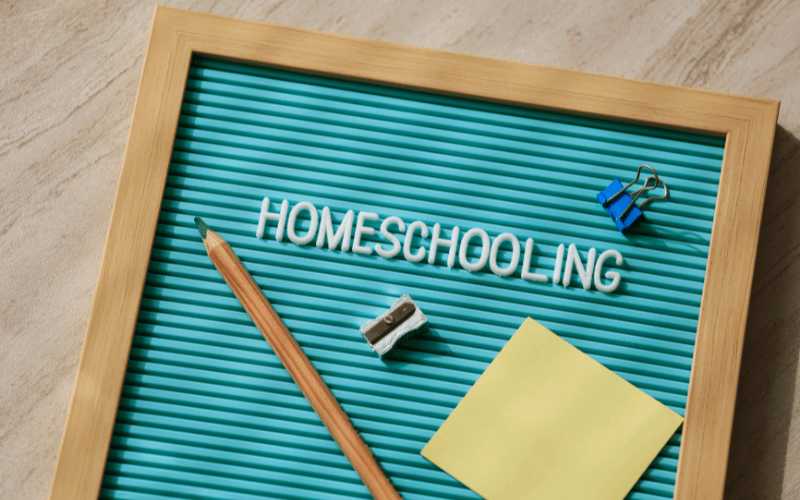 homeschooling written on a board with a shrapener, pencil, clip, and sticky notepad