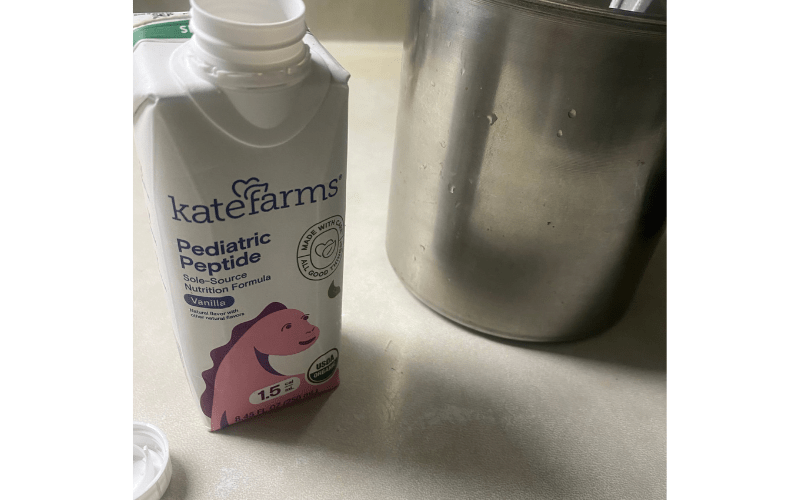 kate farms next to a giant aluminum mug that contains homemade dominican oatmeal shakes