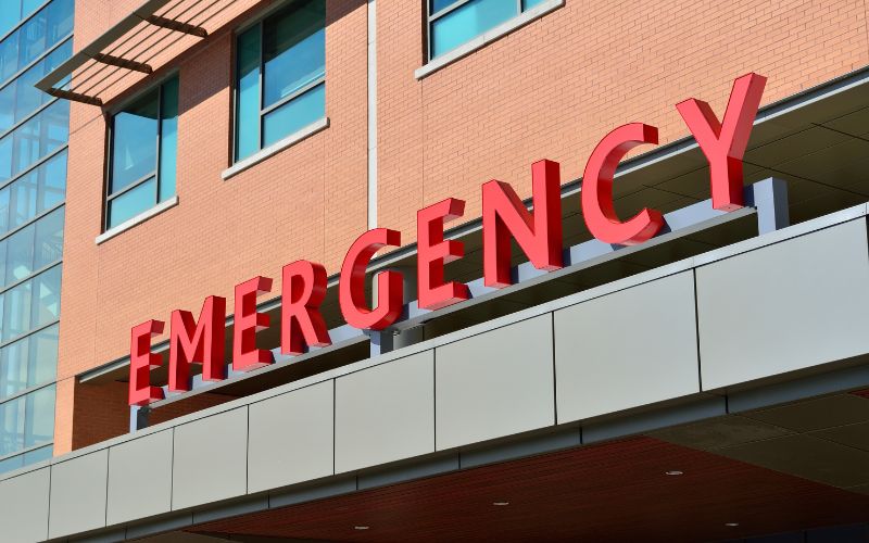 hospital building with the letters emergency in red letters